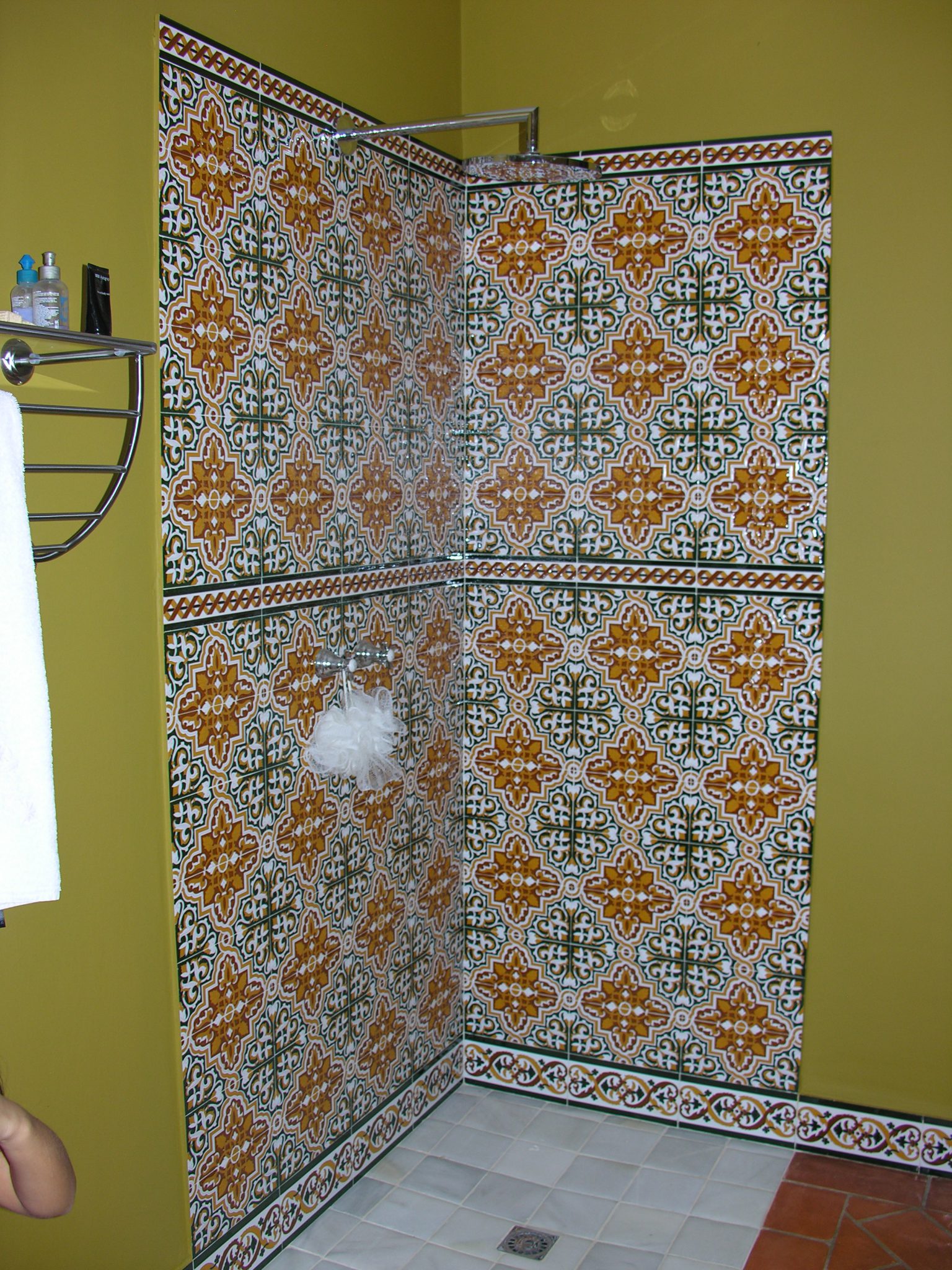 Baño con panel artesano en la ducha y zócalo decorado